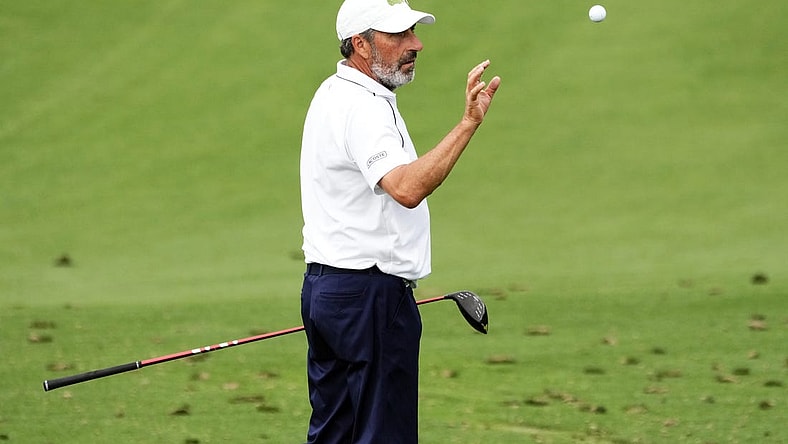 Apr 3, 2023; Augusta, Georgia, USA; Jose Maria Olazabal catches a ball tossed by his caddie on the practice range during a practice round for The Masters golf tournament at Augusta National Golf Club. Mandatory Credit: Rob Schumacher-USA TODAY Network