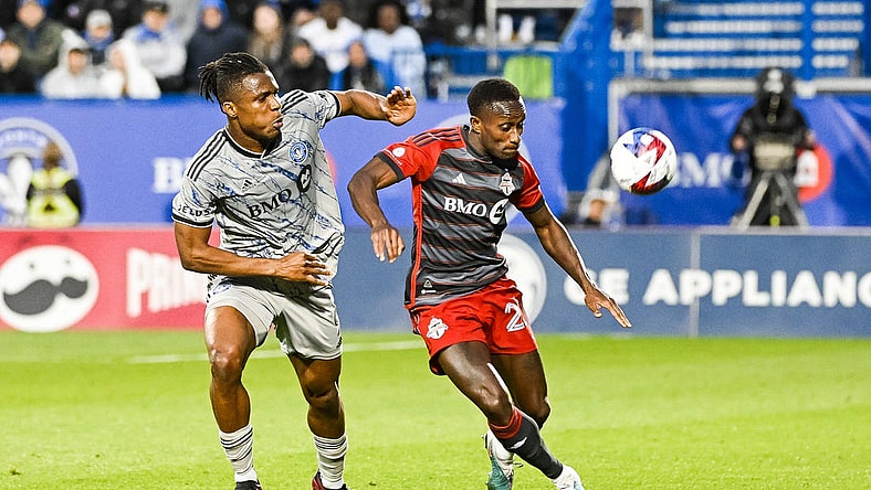 May 13, 2023; Montreal, Quebec, CAN; CF Montreal forward Chinonso Offor (9) and Toronto FC defender Richie Laryea (22) during the first half at Stade Saputo. Mandatory Credit: David Kirouac-USA TODAY Sports