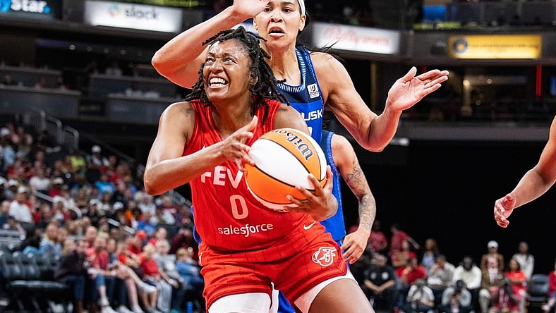 May 19, 2023; Indianapolis, Indiana, USA; Indiana Fever guard Kelsey Mitchell (0) shoots the ball while Connecticut Sun center Brionna Jones (42) defends in the second half at Gainbridge Fieldhouse. Mandatory Credit: Trevor Ruszkowski-USA TODAY Sports