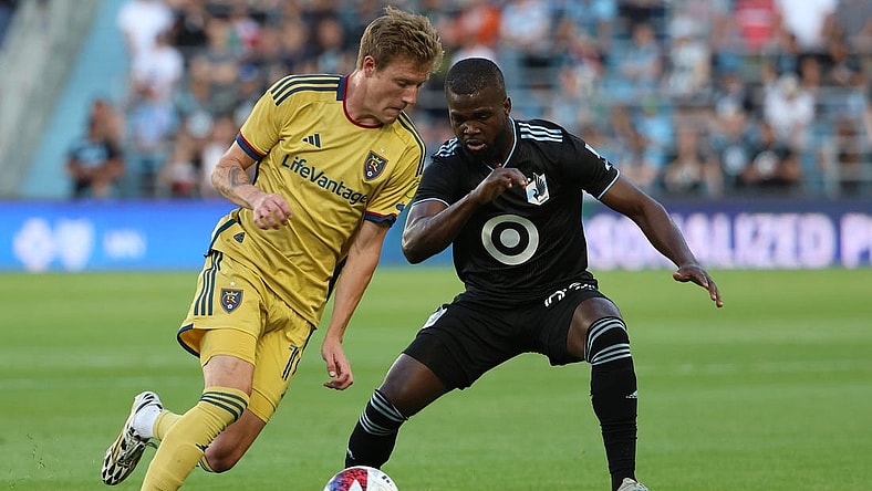 May 27, 2023; Saint Paul, Minnesota, USA; Real Salt Lake midfielder Bode Hidalgo (19) dribbles the past Minnesota United defender Kemar Lawrence (92) during the game at Allianz Field. Mandatory Credit: Matt Krohn-USA TODAY Sports