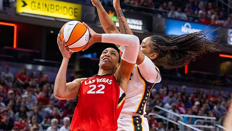 Jun 4, 2023; Indianapolis, Indiana, USA; Las Vegas Aces forward A'ja Wilson (22) shoots the ball while Indiana Fever guard Victoria Vivians (35) defends in the second half at Gainbridge Fieldhouse. Mandatory Credit: Trevor Ruszkowski-USA TODAY Sports
