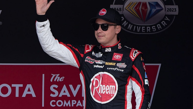 Jun 11, 2023; Sonoma, California, USA;  NASCAR Cup Series driver Christopher Bell (20) waves at the crowd before the start of the Toyota / Save Mart 350 at Sonoma Raceway. Mandatory Credit: Stan Szeto-USA TODAY Sports