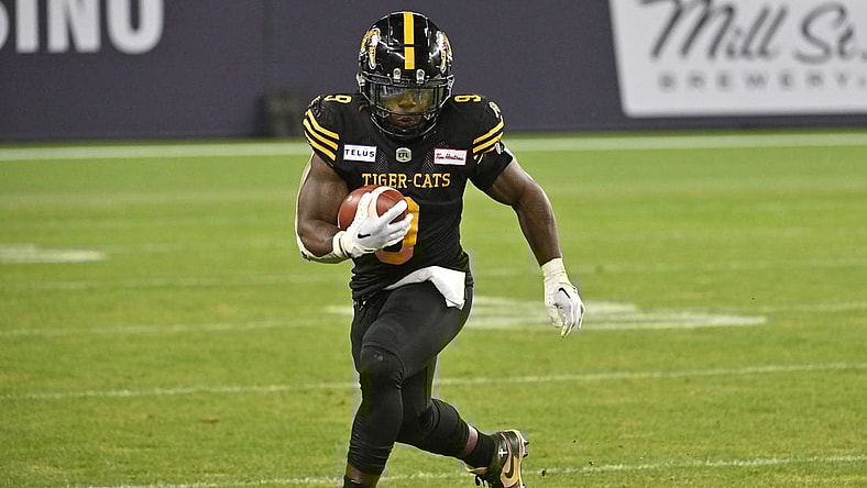 Jun 18, 2023; Toronto, Ontario, CAN;  Hamilton Tiger-Cats running back James Butler (9) runs with the ball against the Toronto Argonauts in the fourth quarter at BMO Field. Mandatory Credit: Dan Hamilton-USA TODAY Sports