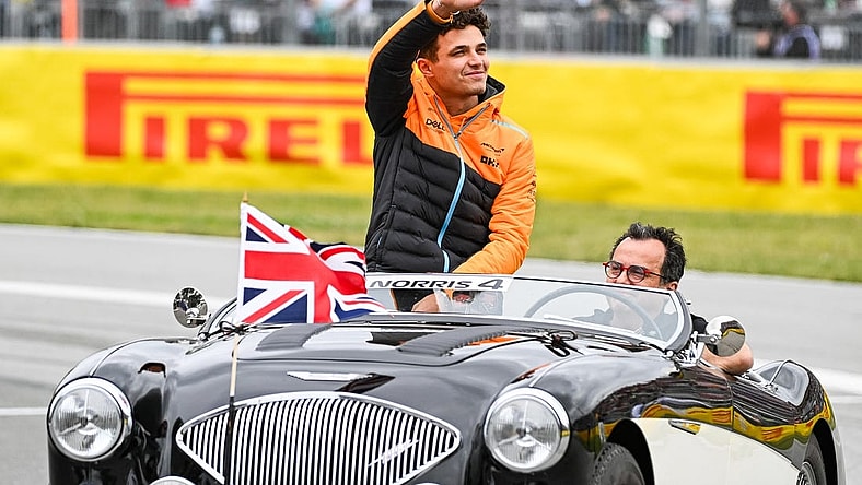 Jun 18, 2023; Montreal, Quebec, CAN; McLaren driver Lando Norris (GBR) parades and salutes the crowd before the Canadian Grand Prix at Circuit Gilles Villeneuve. Mandatory Credit: David Kirouac-USA TODAY Sports