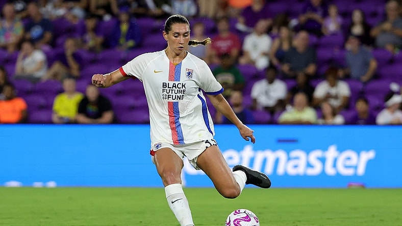 Jul 7, 2023; Orlando, Florida, USA; OL Reign midfielder Olivia Van der Jagt (33) kicks the ball against the Orlando Pride during the second half at Exploria Stadium. Mandatory Credit: Mike Watters-USA TODAY Sports