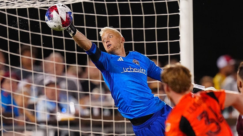 Jul 15, 2023; Commerce City, Colorado, USA; Colorado Rapids goalkeeper William Yarbrough (22) makes an incredible save against the Houston Dynamo FC during the second half at Dick's Sporting Goods Park. Mandatory Credit: Ron Chenoy-USA TODAY Sports