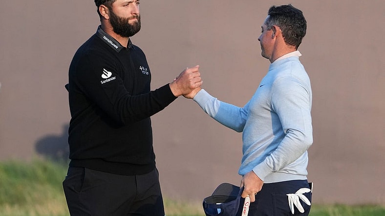 July 20, 2023; Hoylake, England, GBR; Jon Rahm (left) and Rory McIlroy shake hands after completing their first round of The Open Championship golf tournament at Royal Liverpool. Mandatory Credit: Kyle Terada-USA TODAY Sports