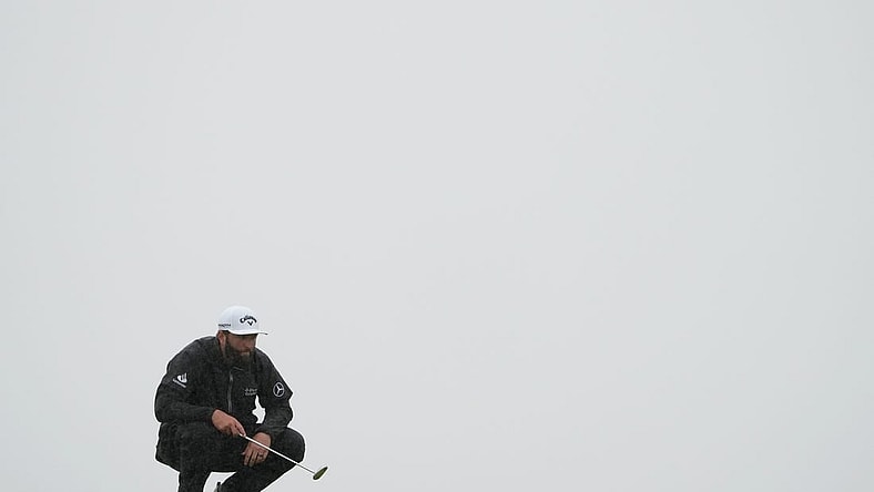 Jul 23, 2023; Hoylake, England, GBR; Jon Rahm lines up a putt on the 13th green during the final round of The Open Championship golf tournament. Mandatory Credit: Kyle Terada-USA TODAY Sports