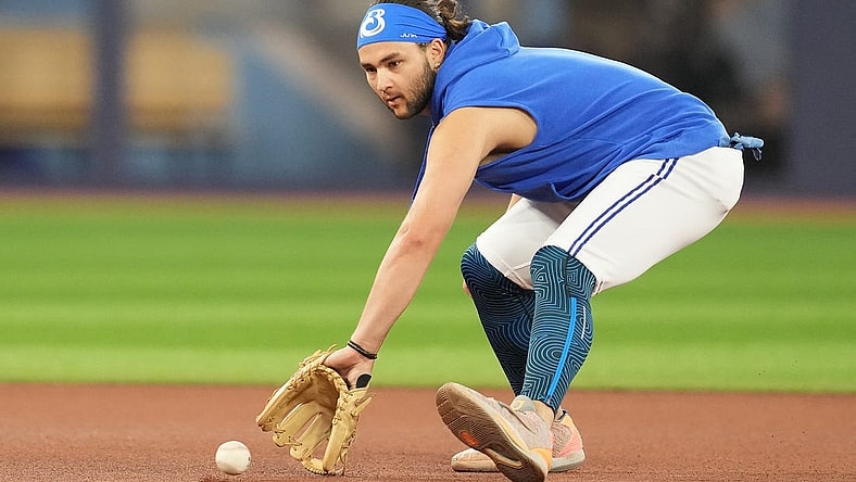 Jul 31, 2023; Toronto, Ontario, CAN; Toronto Blue Jays shortstop Bo Bichette (11) fields balls during batting practice before a game against the Baltimore Orioles at Rogers Centre. Mandatory Credit: Nick Turchiaro-USA TODAY Sports