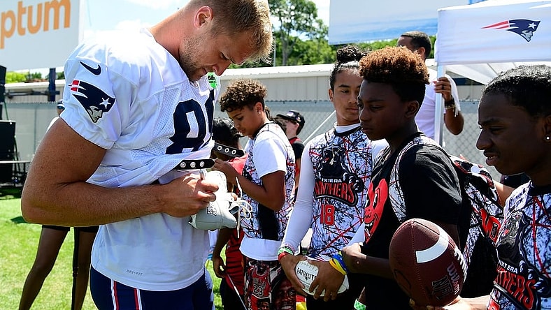 Aug 1, 2023; Foxborough, MA, USA; New England Patriots tight end Mike Gesicki (88) signs an autograph for a fan at training camp at Gillette Stadium. Mandatory Credit: Eric Canha-USA TODAY Sports