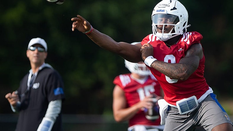 Kansas junior quarterback Jalon Daniels (6) practices passes during Tuesday's outdoor practice.