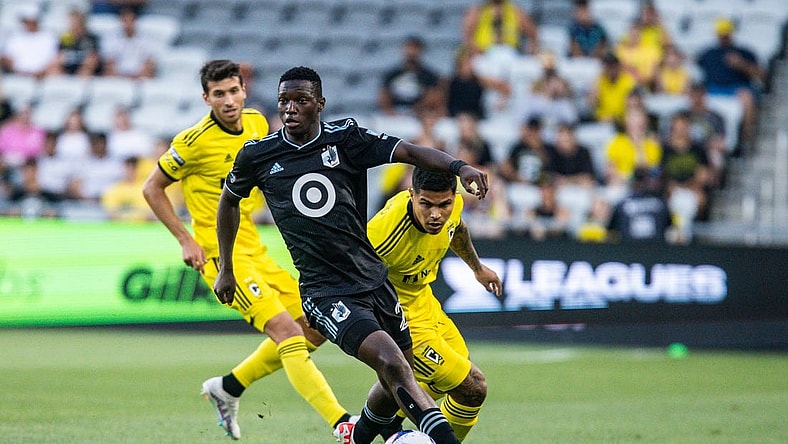 Aug 4, 2023; Columbus, OH, USA;  Minnesota United forward Bongokuhle Hlongwane (21) dribbles the ball while Columbus Crew forward Cucho Hernandez (9) defends in the first half at Lower.com Field. Mandatory Credit: Trevor Ruszkowski-USA TODAY Sports