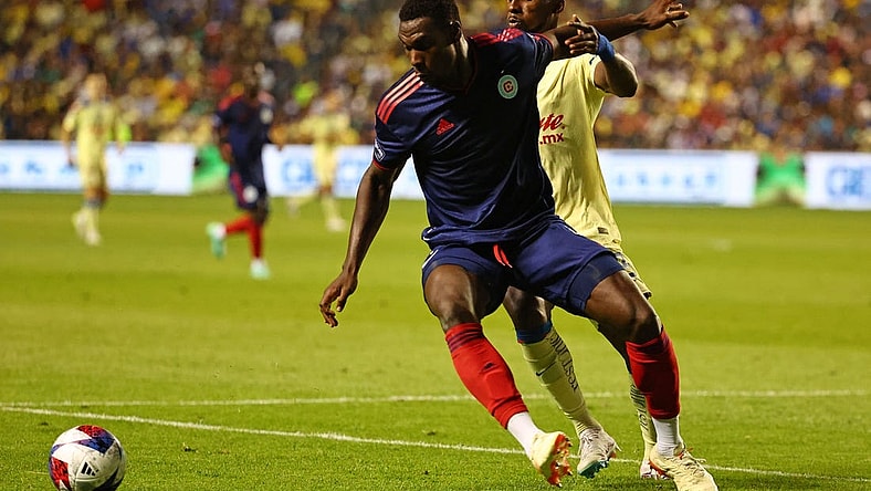 Aug 4, 2023; Bridgeview, IL, USA; Chicago Fire defender Carlos Teran (4) kicks the ball past Club America forward Julian Quinones (33) during the second half at SeatGeek Stadium. Mandatory Credit: Mike Dinovo-USA TODAY Sports