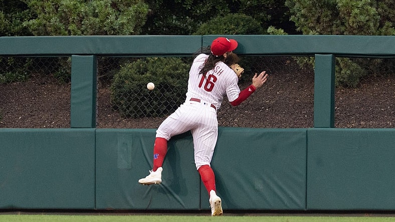 Aug 5, 2023; Philadelphia, Pennsylvania, USA; Philadelphia Phillies center fielder Brandon Marsh (16) is injured while attempting to catch the triple of Kansas City Royals second baseman Samad Taylor (not pictured) during the fifth inning at Citizens Bank Park. Mandatory Credit: Bill Streicher-USA TODAY Sports
