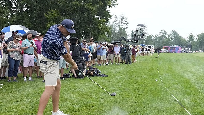 Aug 6, 2023; White Sulphur Springs, West Virginia, USA; Bryson DeChambeau hits his approach shot from the rough on 17 during the final round of the LIV Golf event at The Old White Course. Mandatory Credit: Bob Donnan-USA TODAY Sports