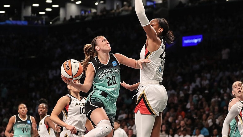 Aug 6, 2023; Brooklyn, New York, USA;  New York Liberty guard Sabrina Ionescu (20) looks to drive past Las Vegas Aces forward A'ja Wilson (22) in the first quarter at Barclays Center. Mandatory Credit: Wendell Cruz-USA TODAY Sports