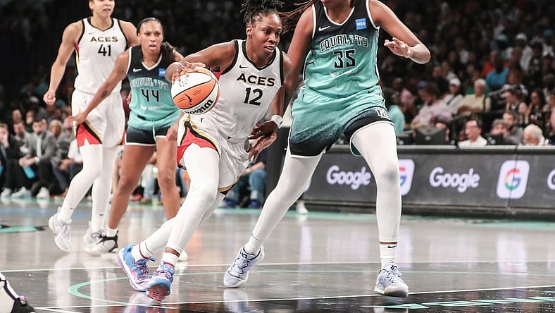 Aug 6, 2023; Brooklyn, New York, USA;  Las Vegas Aces guard Chelsea Gray (12) looks to drive past New York Liberty forward Jonquel Jones (35) in the third quarter at Barclays Center. Mandatory Credit: Wendell Cruz-USA TODAY Sports