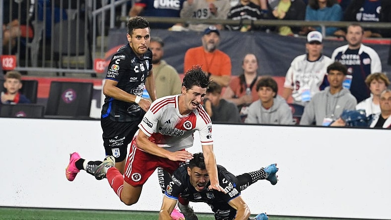 Aug 7, 2023; Foxborough, MA, USA; New England Revolution forward Jozy Altidore (14) (red) and Queretaro FC midfielder Federico Lertora (14) (black) get tangled  during the second half at Gillette Stadium. Mandatory Credit: Eric Canha-USA TODAY Sports
