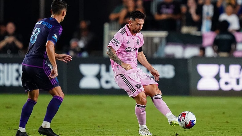Aug 11, 2023; Fort Lauderdale, FL, USA; Inter Miami CF forward Lionel Messi (10) plays the ball as Charlotte FC midfielder Ashley Westwood (8) defends in the first half at DRV PNK Stadium. Mandatory Credit: John David Mercer-USA TODAY Sports