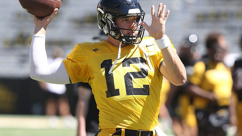 Iowa quarterback Cade McNamara (12) warms up before practice during Kids' Day at Kinnick Stadium on Saturday, Aug. 12, 2023, in Iowa City, Iowa