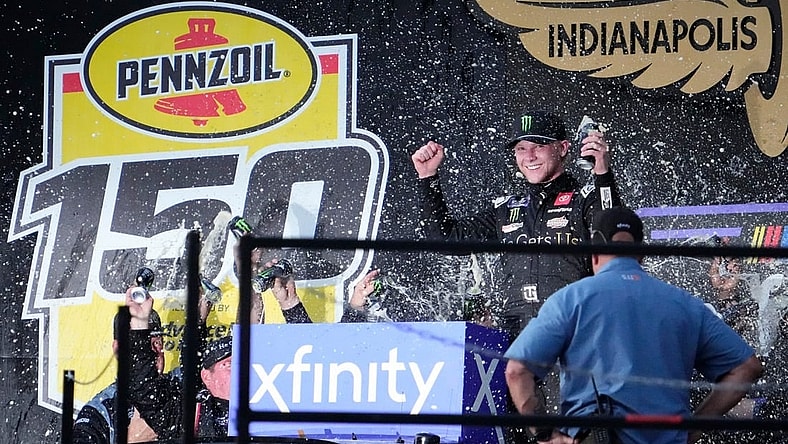 NASCAR Xfinity Series driver Ty Gibbs (19) celebrates on the victory podium Saturday, Aug. 12, 2023, following the NASCAR Xfinity Series Pennzoil 150 at Indianapolis Motor Speedway.
