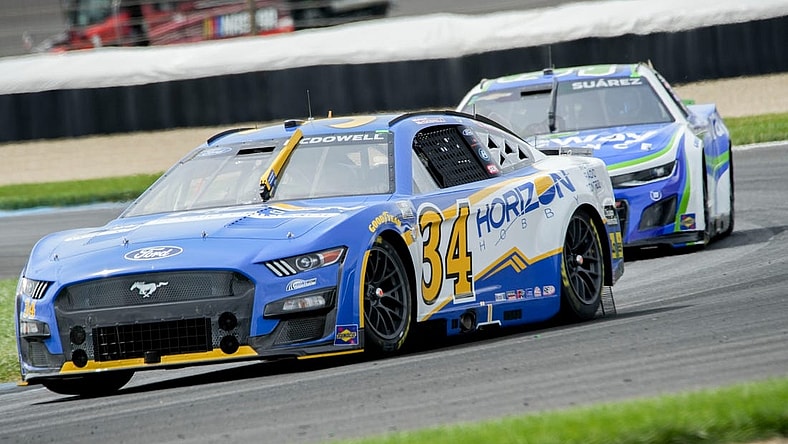 NASCAR Cup Series driver Michael McDowell (34) leads NASCAR Cup Series driver Chase Elliott (9) around the track Sunday, Aug. 13, 2023, before winning the Verizon 200 at the Brickyard at Indianapolis Motor Speedway.