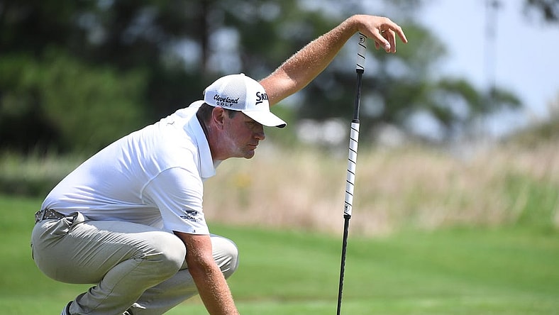 Aug 13, 2023; Memphis, Tennessee, USA; Lucas Glover works with his caddie to line up a putt during the final round of the FedEx St. Jude Championship golf tournament. Mandatory Credit: Christopher Hanewinckel-USA TODAY Sports