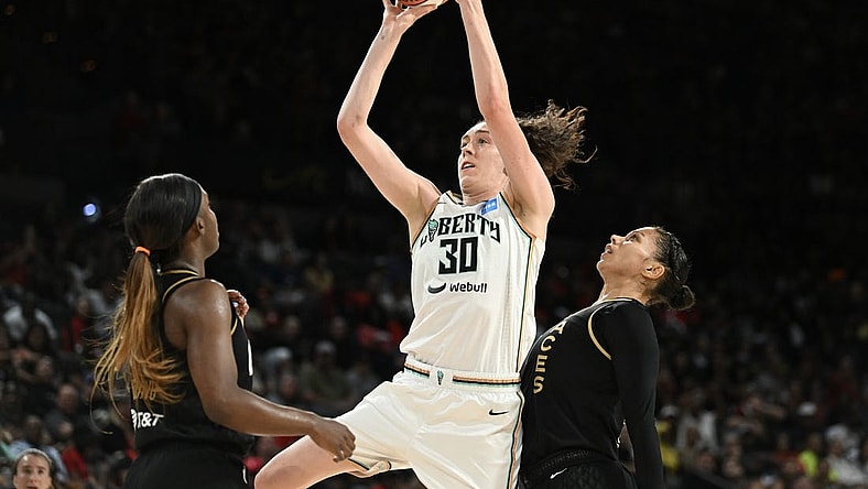 Aug 15, 2023; Las Vegas, Nevada, USA; New York Liberty forward Breanna Stewart (30) takes a shot against Las Vegas Aces guard Jackie Young (0) and forward Alysha Clark (7) during the second quarter at Michelob Ultra Arena. Mandatory Credit: Candice Ward-USA TODAY Sports
