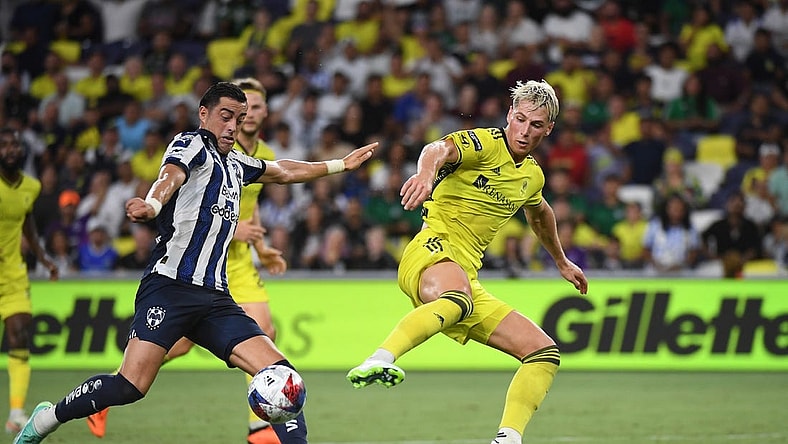 Aug 15, 2023; Nashville, TN, USA; CF Monterrey forward Rogelio Funes Mori (7) plays the ball defined by Nashville SC defender Lukas MacNaughton (3) in the first half at GEODIS Park. Mandatory Credit: Christopher Hanewinckel-USA TODAY Sports
