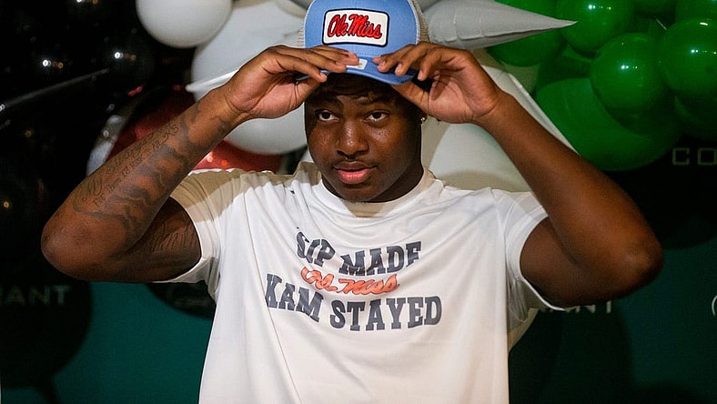 Kamarion Franklin, the No. 1 recruit in Mississippi, puts on an Ole Miss hat as he announces his commitment to Ole Miss football while wearing a shirt that says       Sip Made Kam Stayed    with the Ole Miss logo at Lake Cormorant High School in Lake Cormorant, Miss, on Saturday, August 19, 2023.