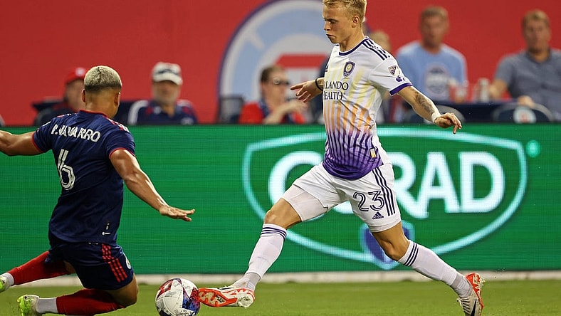 Aug 20, 2023; Chicago, Illinois, USA; Chicago Fire defender Miguel Angel Navarro (6) slide tackles against Orlando City midfielder Dagur Dan Thorhallsson (23) during the first half at Soldier Field. Mandatory Credit: Jon Durr-USA TODAY Sports