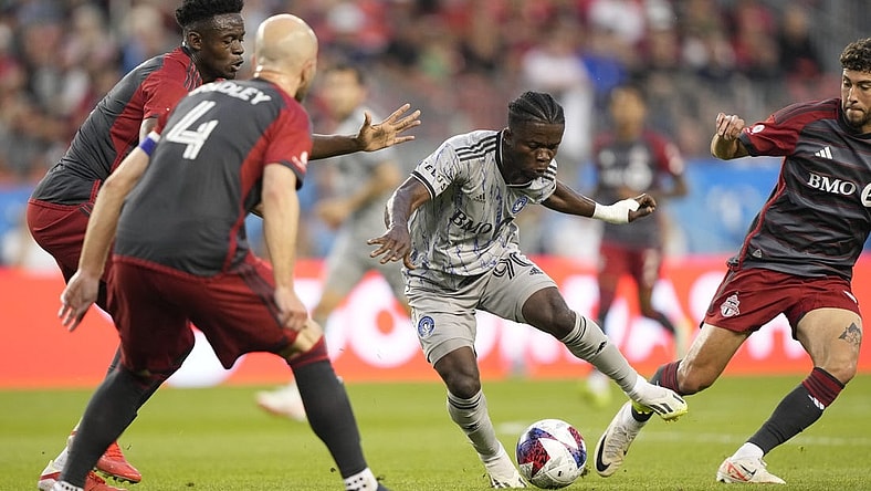 Aug 20, 2023; Toronto, Ontario, CAN; CF Montr al forward Kwadwo Opoku (90) controls the ball while defended by several Toronto FC players during the first half at BMO Field. Mandatory Credit: John E. Sokolowski-USA TODAY Sports