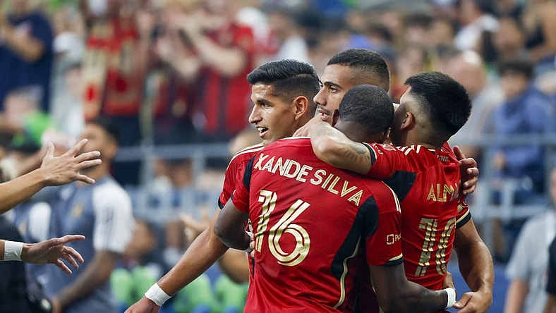 Aug 20, 2023; Seattle, Washington, USA; Atlanta United forward Giorgos Giakoumakis (7, second from left) celebrates with defender Luis Abram (4, left), forward Xande Silva (16) and midfielder Luiz Araujo (10) after scoring a goal against the Seattle Sounders FC during the first half at Lumen Field. Mandatory Credit: Joe Nicholson-USA TODAY Sports