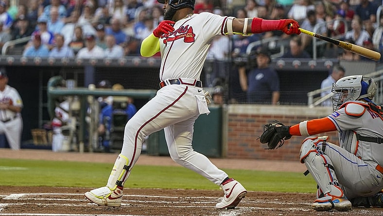 Aug 23, 2023; Cumberland, Georgia, USA; Atlanta Braves designated hitter Marcell Ozuna (20) drives in a run with a single against the New York Mets during the first inning at Truist Park. Mandatory Credit: Dale Zanine-USA TODAY Sports
