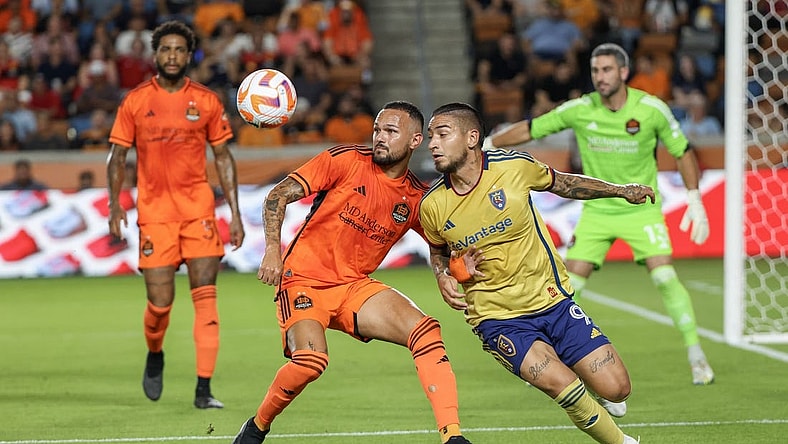 Aug 23, 2023; Houston, TX, USA;Houston Dynamo midfielder Artur (6) and Real Salt Lake forward Christian Chico Arango (9) tie each other up in the first half at Shell Energy Stadium. Mandatory Credit: Thomas Shea-USA TODAY Sports
