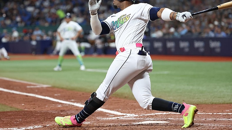 Aug 25, 2023; St. Petersburg, Florida, USA; Tampa Bay Rays first baseman Yandy Diaz (2) hits a home run against the New York Yankees during the sixth inning at Tropicana Field. Mandatory Credit: Kim Klement Neitzel-USA TODAY Sports