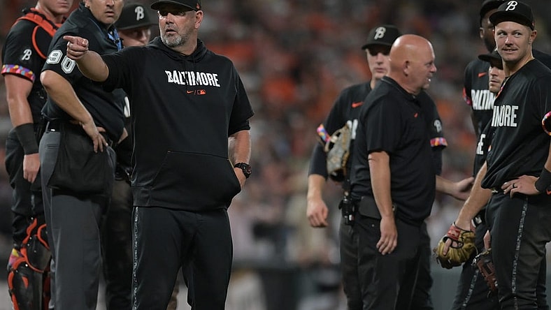 Aug 25, 2023; Baltimore, Maryland, USA;  Baltimore Orioles manager Brandon Hyde (18) signals to the dugout after relief pitcher Felix Bautista (74) slipped on the pitcher's mound during the ninth inning against the Colorado Rockies at Oriole Park at Camden Yards. Mandatory Credit: Tommy Gilligan-USA TODAY Sports