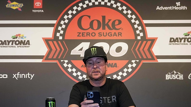 Aug 26, 2023; Daytona Beach, Florida, USA;  Kurt Busch reads from a prepared statement announcing his retirement prior to the Coke Zero Sugar 400 at Daytona International Speedway. Mandatory Credit: David Yeazell-USA TODAY Sports