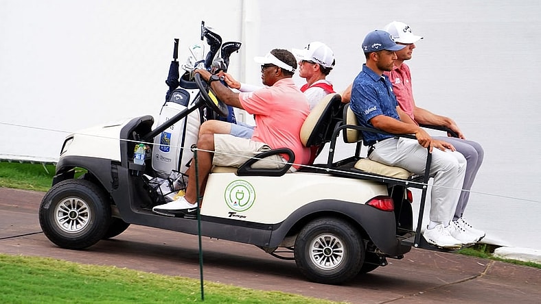 Aug 26, 2023; Atlanta, Georgia, USA; Xander Schauffele and Sam Burns are carted off the course after the horn was blown for a weather delay during the third round of the TOUR Championship golf tournament at East Lake Golf Club. Mandatory Credit: John David Mercer-USA TODAY Sports
