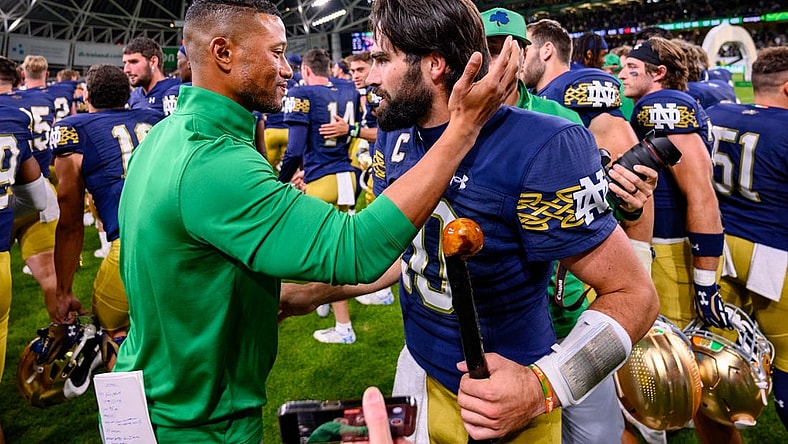 Aug 26, 2023; Dublin, IRL; Notre Dame Fighting Irish head coach Marcus Freeman, left, celebrates with quarterback Sam Hartman (10) after Notre Dame defeated the Navy Midshipmen 42-3 at Aviva Stadium. Mandatory Credit: Matt Cashore-USA TODAY Sports