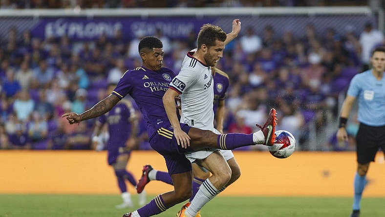 Aug 26, 2023; Orlando, Florida, USA; Orlando City SC midfielder Wilder Cartagena (16) and St. Louis City SC midfielder Indiana Vassilev (19) battle for the ball in the first half at Exploria Stadium. Mandatory Credit: Morgan Tencza-USA TODAY Sports