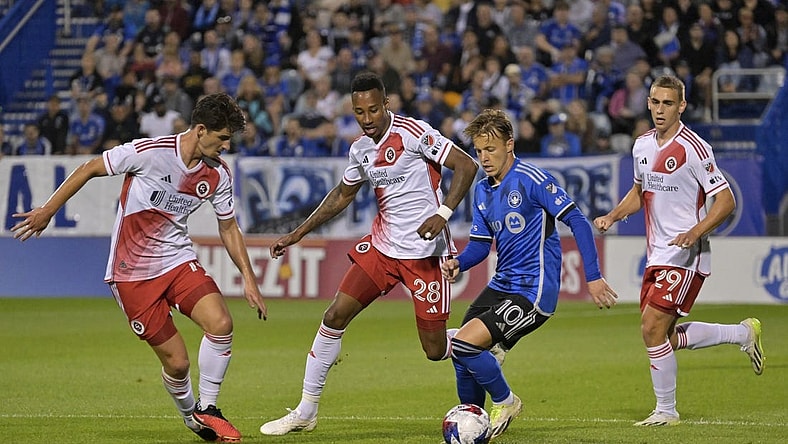 Aug 26, 2023; Montreal, Quebec, CAN; CF Montreal midfielder Bryce Duke (10) dribbles the ball around New England Revolution midfielder Mark-Anthony Kaye (28) and midfielder Ian Harkes (14) during the first half at Stade Saputo. Mandatory Credit: Eric Bolte-USA TODAY Sports