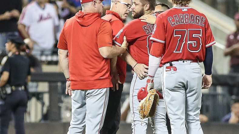 Aug 26, 2023; New York City, New York, USA;  Los Angeles Angels starting pitcher Chase Silseth (63) is checked on after getting hit in the head by a throw in the fourth inning against the New York Mets at Citi Field. Mandatory Credit: Wendell Cruz-USA TODAY Sports