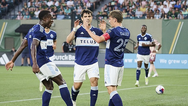 Aug 26, 2023; Portland, Oregon, USA; Vancouver Whitecaps midfielder Ryan Gauld (25) celebrates with teammates after scoring a goal in the first half against the Portland Timbers at Providence Park. Mandatory Credit: Troy Wayrynen-USA TODAY Sports