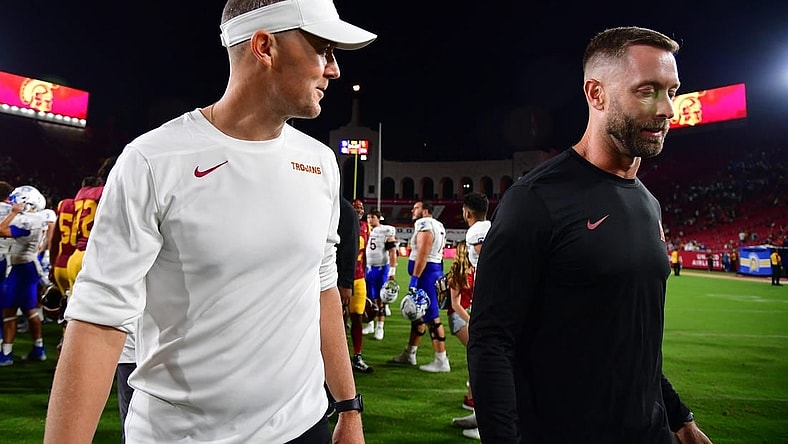Aug 26, 2023; Los Angeles, California, USA; Southern California Trojans head coach Lincoln Riley speaks with assistant coach Kliff Kingsbury following the victory against the San Jose State Spartans at Los Angeles Memorial Coliseum. Mandatory Credit: Gary A. Vasquez-USA TODAY Sports