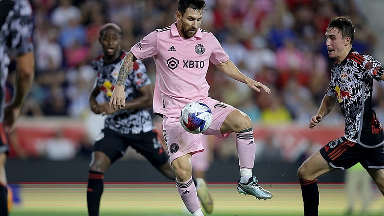 Aug 26, 2023; Harrison, New Jersey, USA; Inter Miami CF forward Lionel Messi (10) controls the ball against New York Red Bulls defender Andres Reyes (4) and midfielder Peter Stroud (5) during the second half at Red Bull Arena. Mandatory Credit: Brad Penner-USA TODAY Sports