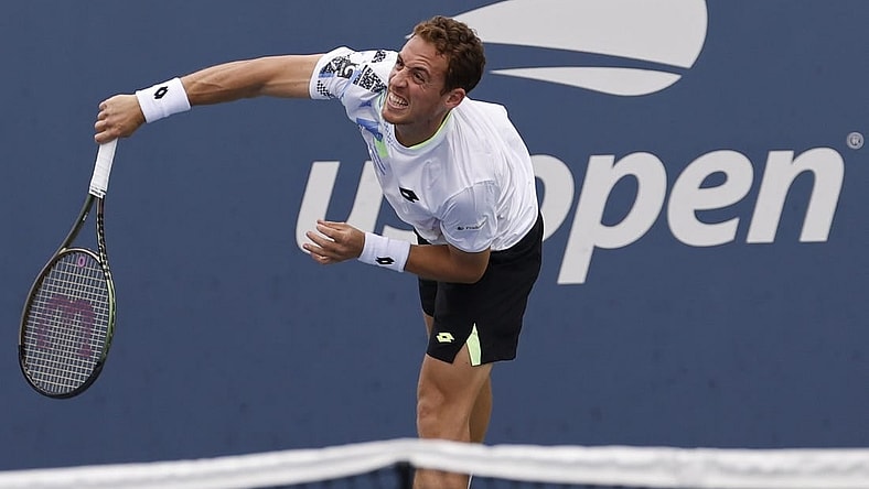 Aug 28, 2023; Flushing, NY, USA; Roberto Carballes Baena of Spain serves against Hulger Rune of Denmark (not pictured) on day one of the 2023 US Open at the Billie Jean King National Tennis Center. Mandatory Credit: Geoff Burke-USA TODAY Sports