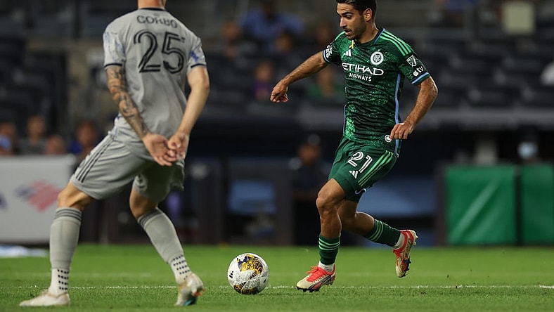 Aug 30, 2023; New York, New York, USA; New York City forward Andres Jasson (21) runs with the ball against CF Montreal defender Gabriele Corbo (25) during the first half at Yankee Stadium. Mandatory Credit: Vincent Carchietta-USA TODAY Sports