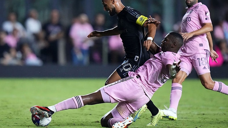 Aug 30, 2023; Fort Lauderdale, Florida, USA; Inter Miami defender Kamal Miller (31) slide tackles Nashville SC midfielder Hany Mukhtar (10) during the second half at DRV PNK Stadium. Mandatory Credit: Rich Storry-USA TODAY Sports