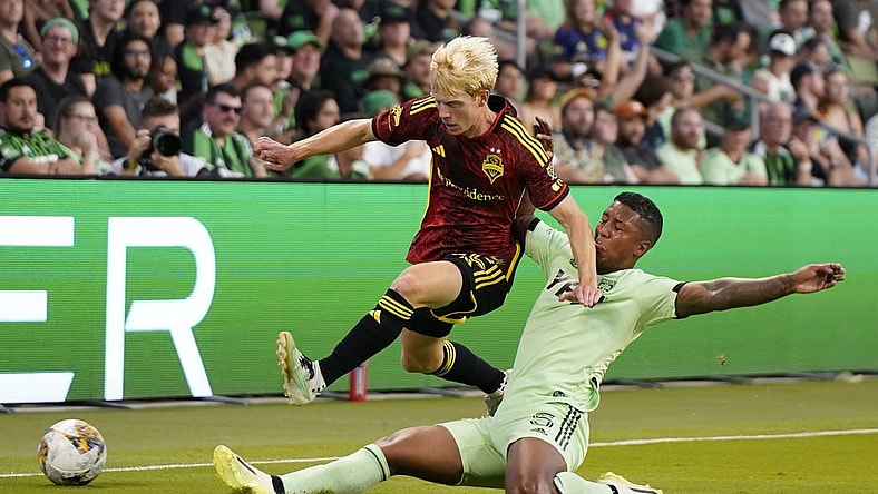 Aug 30, 2023; Austin, Texas, USA; Seattle Sounders midfielder Ethan Dobbelaere (45) is tackled by Austin FC midfielder Jhojan Valencia (5) at Q2 Stadium. Mandatory Credit: Scott Wachter-USA TODAY Sports